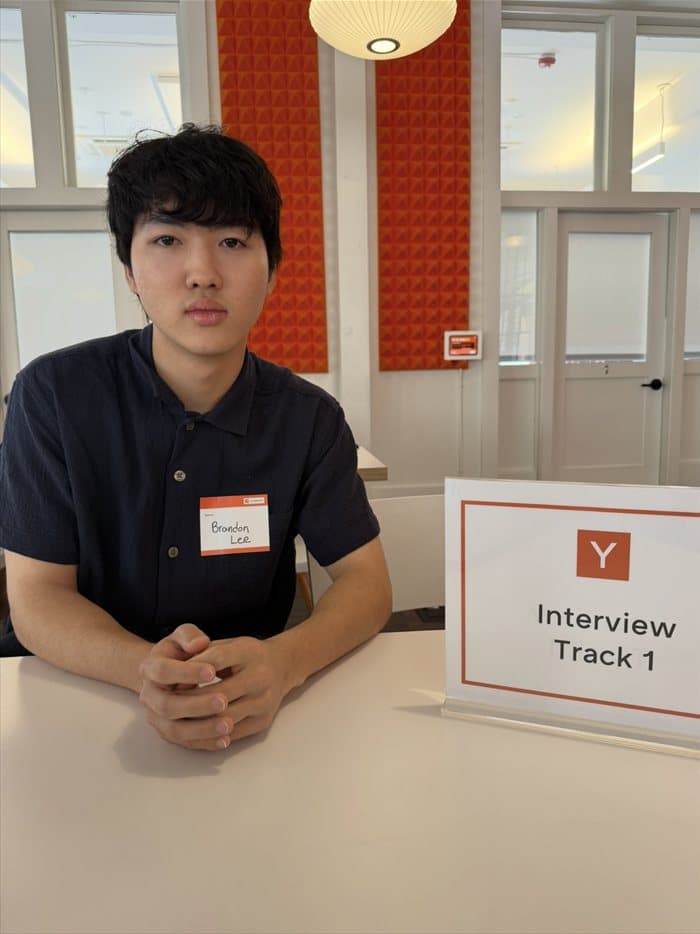 Brandon seated at the Interview Track 1 table at Y Combinator